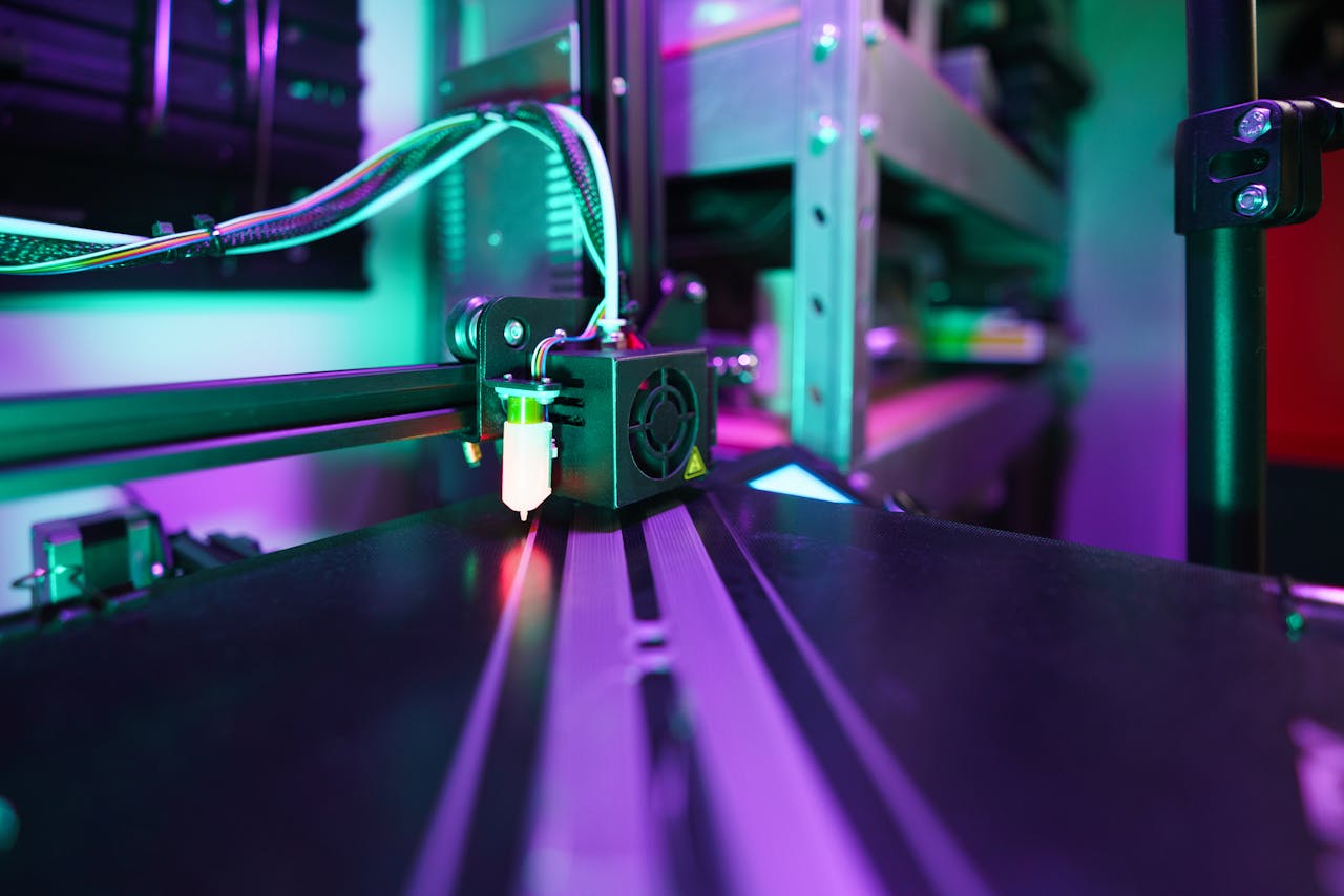 team-02 closeup-of-3d-printer-in-action-with-neon-lighting-34367995